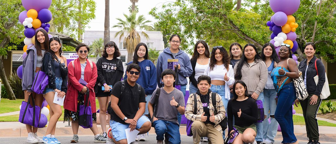 ground of new undergraduate students smiling on campus