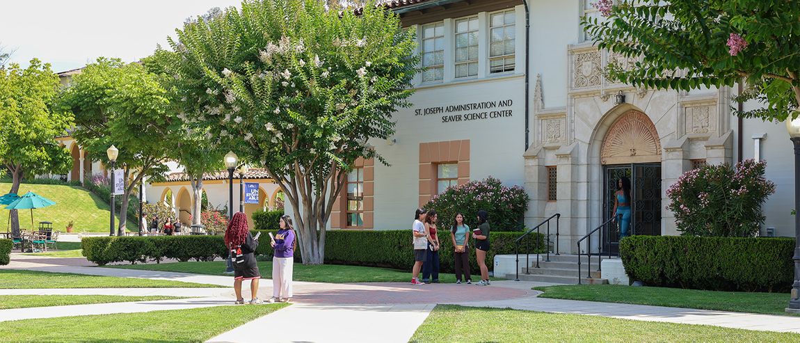 students walking in the quad at chalon campus in front of the saint joseph admin building
