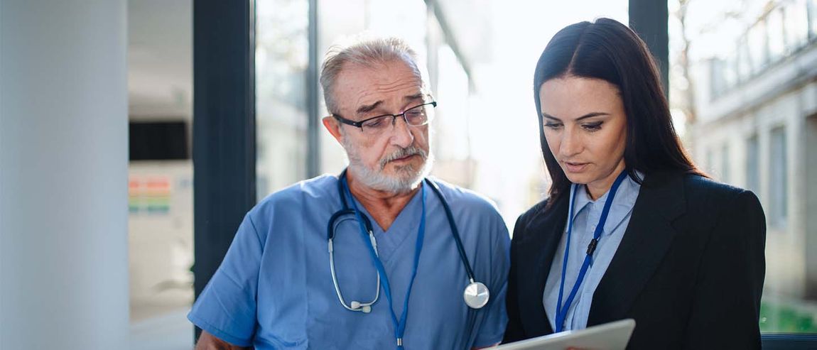 administrator and doctor reviewing paperwork