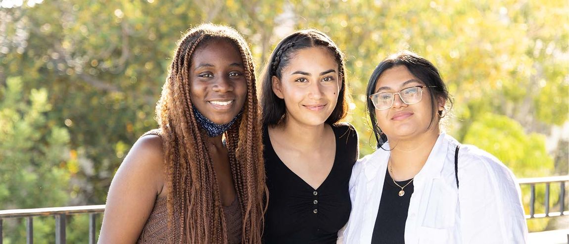 three students smiling