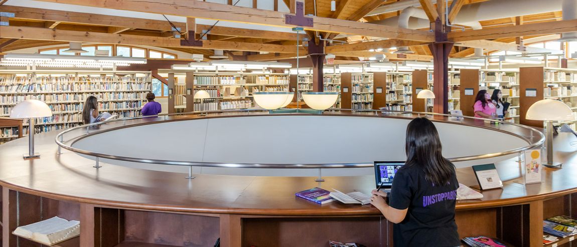Student studying on the second floor of the Doheny library