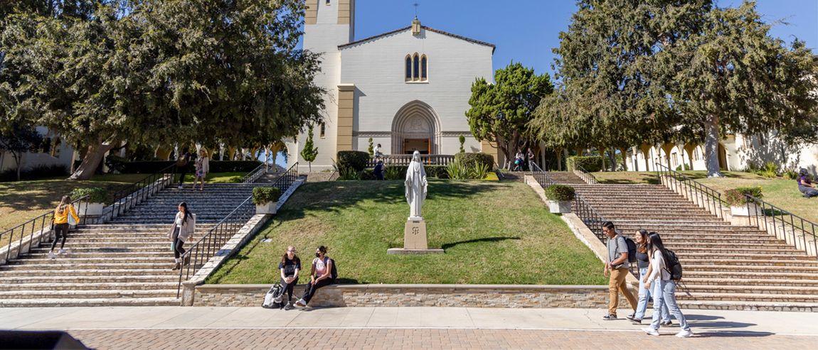Student at the Chalon Campus in front of the Chapel.