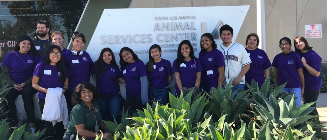 A group photo of 91ɬ�� students standing in front the sign for Animal Services Center in LA.