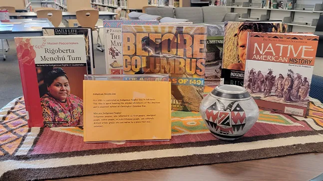 An exhibit featuring books and artifacts celebrates Indigenous People's Day