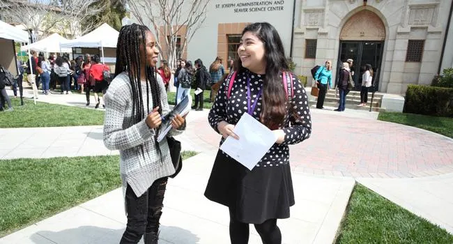 Students talk on the Admin Lawn between presentations at the Mount's 2018 Academic Symposium.