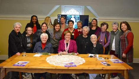 Sister Pat Krommer, Sister Suzanne Jabro and Sister Barbara Stowasser pose with students, sisters and faculty following their talk on prison ministries and their work for restorative justice.