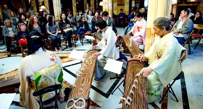 Members of the L.A. Women's Koto Ensemble play during a performance in the Doheny Mansion.