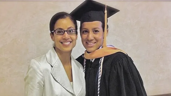 Ruth Racine ’99 at her '11 Uniformed Services University of the Health Sciences graduation in Bethesda, Maryland. With her is sister Blaisy Racine, an RN and also an Army veteran.