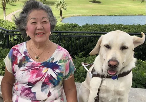 Vicki (Russell) Kennedy ’68 in a photo selected by her husband. “This is one of my most favorite pictures of Vickie with Buddy,” says Jim. “It reflects her vibrancy and the playfulness of her otherwise serious guide.”