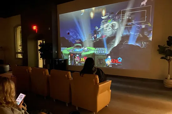 To adhere to COVID-19 protocols, events such as Just Dance and team competitions for the Super Smash tournament were held on a large, blowup movie screen in the student lounge.