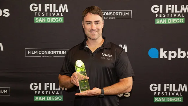 Brian Hanson '16 holding the 2019 GI Festival's Best Actor award given to Frankie Muniz for his work on Hanson's 