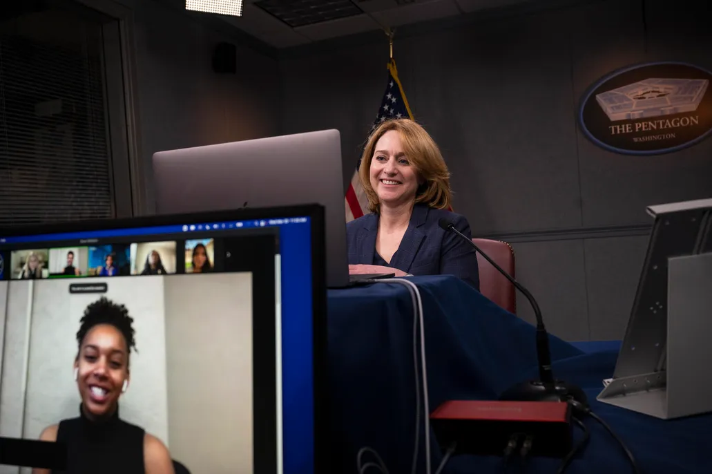 Deputy Secretary of Defense Kathleen Hicks talking with one of the students at the panel.