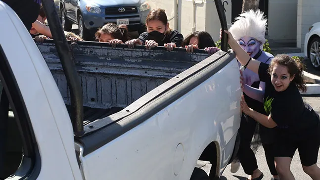 A team participates in the truck push. Anyone recognize the person who went all out in dressing for the Disney villain theme? It's John McQuillan, then-associate director of sports, recreation and wellness, unrecognizable as Ursula. Maybe there should be a prize for best costume.