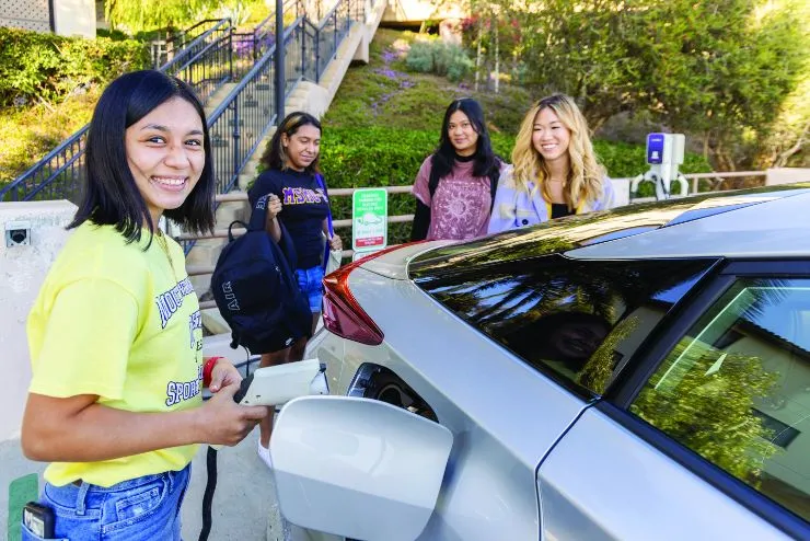 Mount student charging her car at one of Chalon’s EV charging stations.