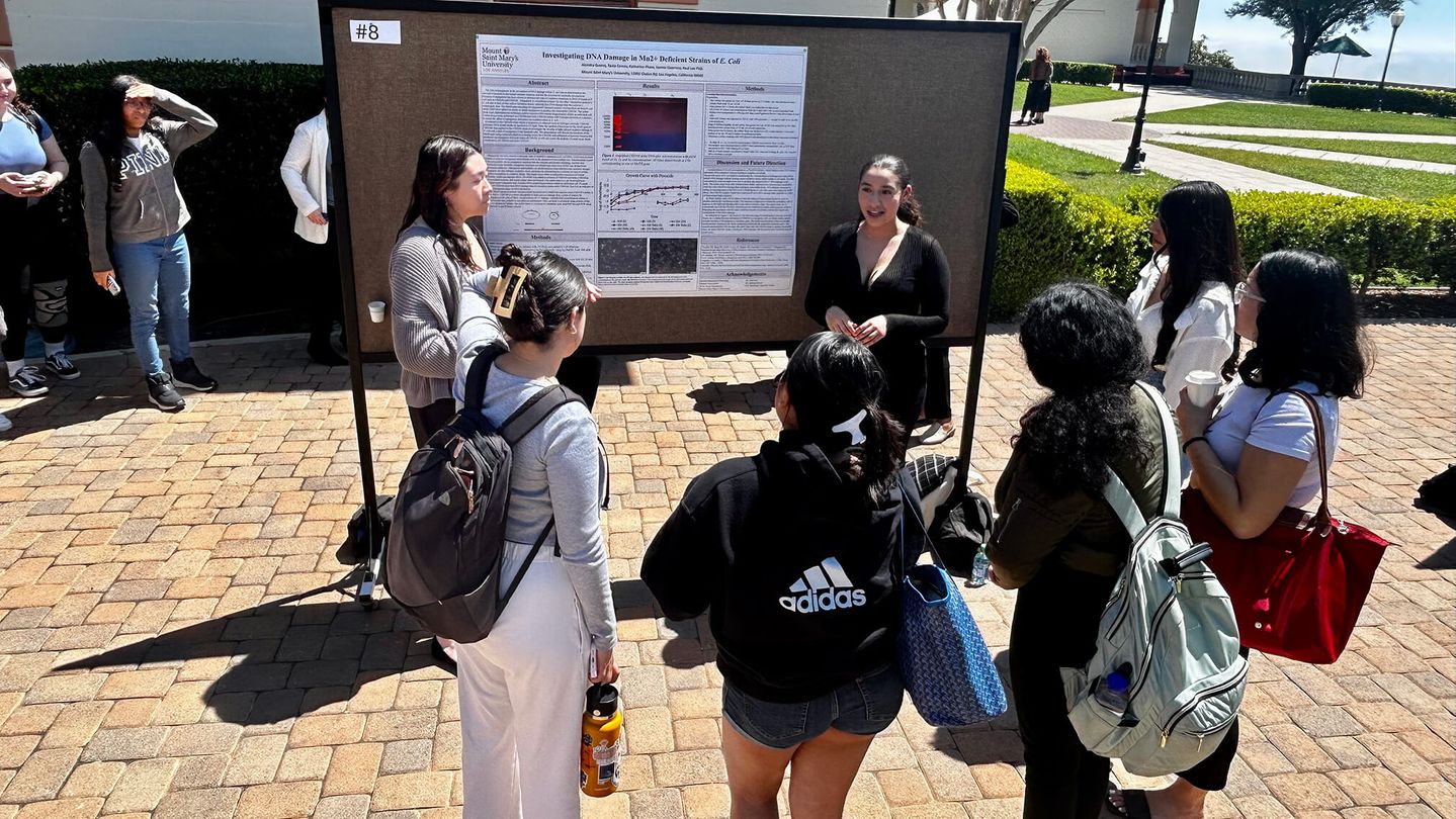 One of the presenters discussing her research at the poster presentation of the 2024 Academic Symposium.