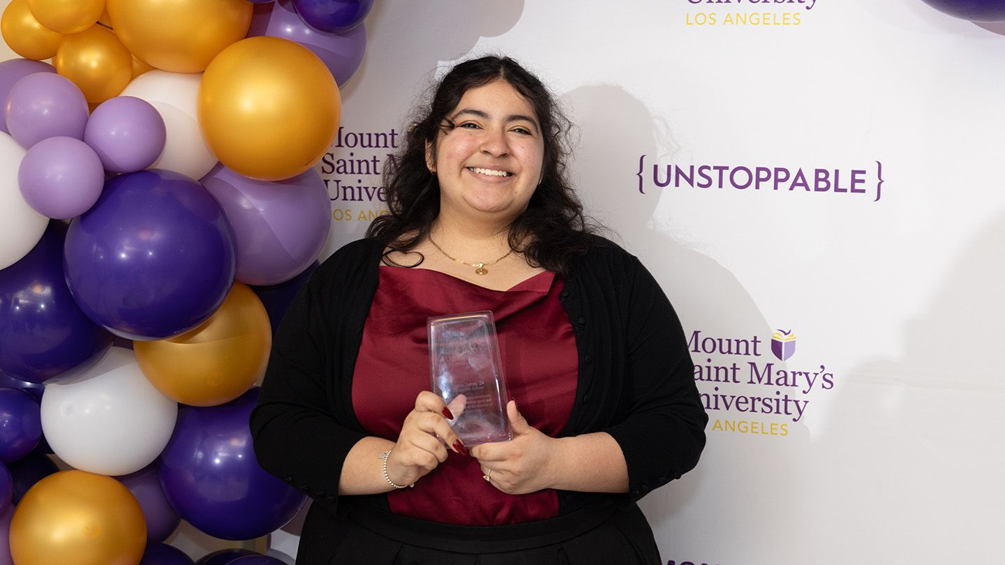 Aurora Torres smiling at an awards ceremony