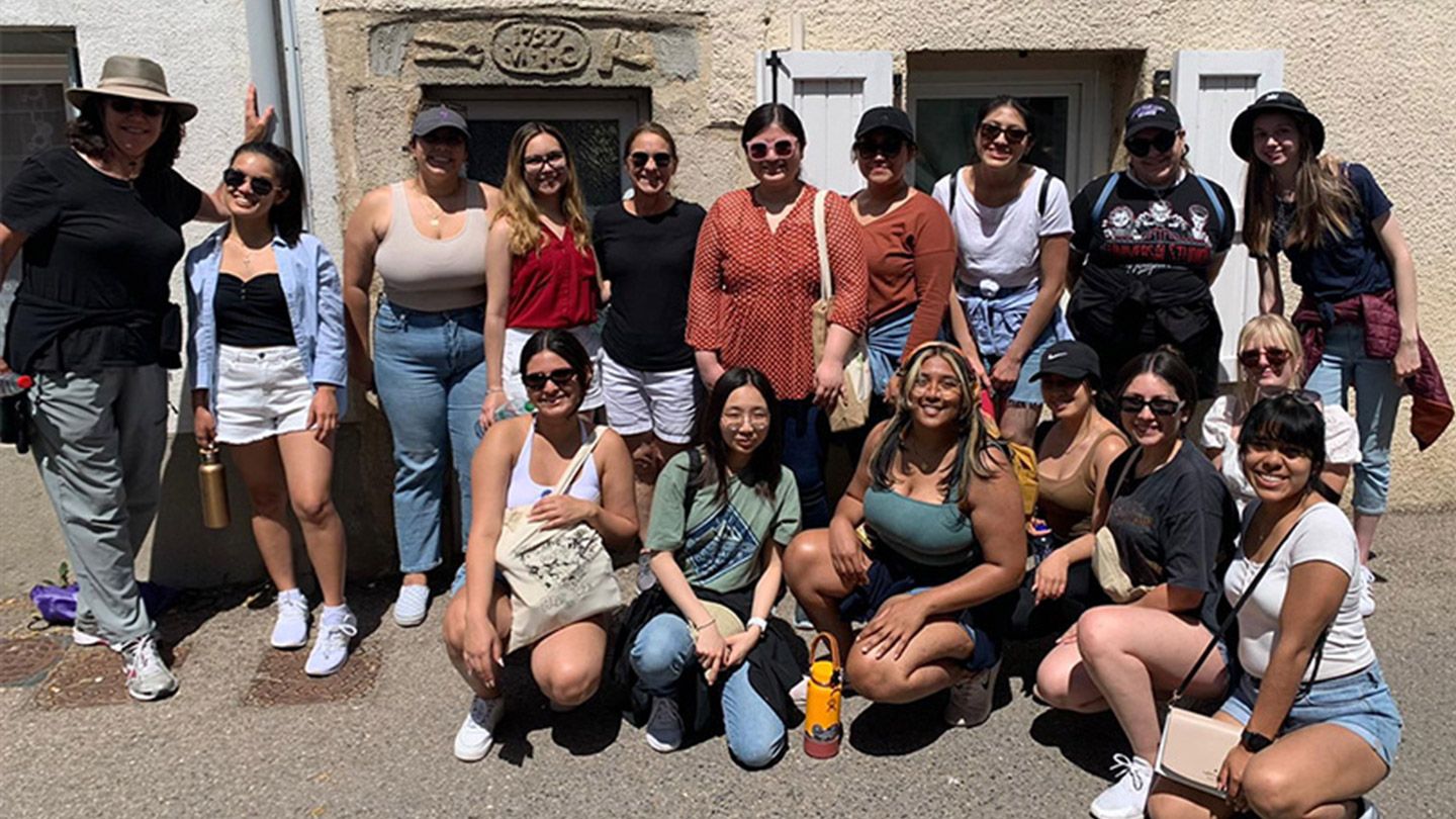 Mount students with President McElaney-Johnson (back row, fifth from left) and Stephanie Cubba, VP of Institutional Advancement (back row, far left).