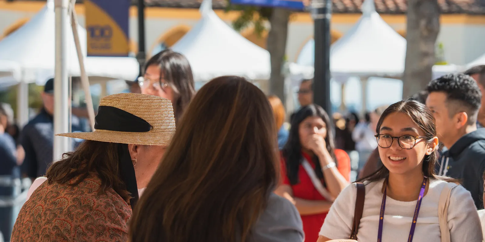 A student and a parent talking with counselors at ASD