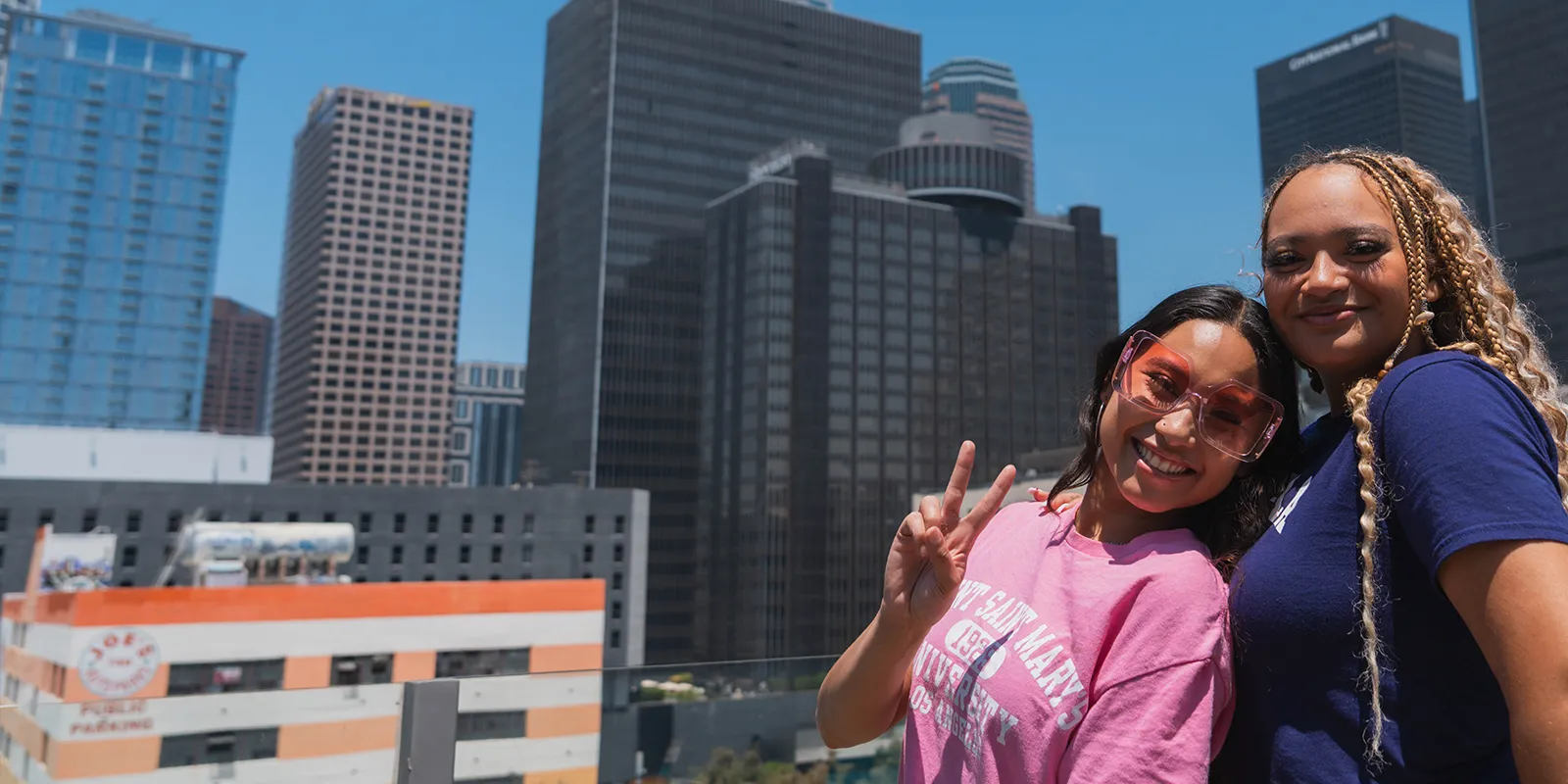 Two ˮ���� students posing in front of Downtown LA