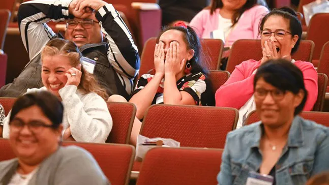 Attendees react during the closing session, “Let them laugh: How improve makes you a better storyteller.”