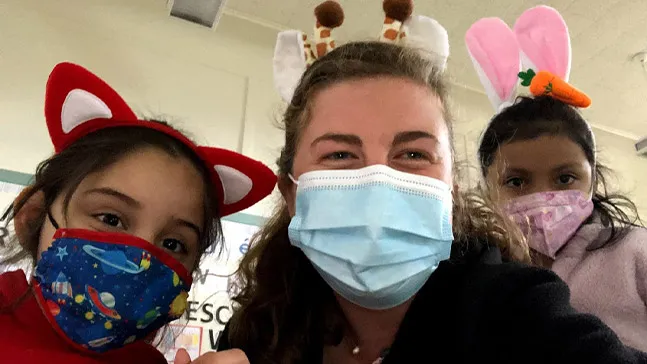 Emily in '21 with some of her students in San Francisco. During that year, she lived in a co-op with 70 housemates, which she said was like college without the homework and tests.