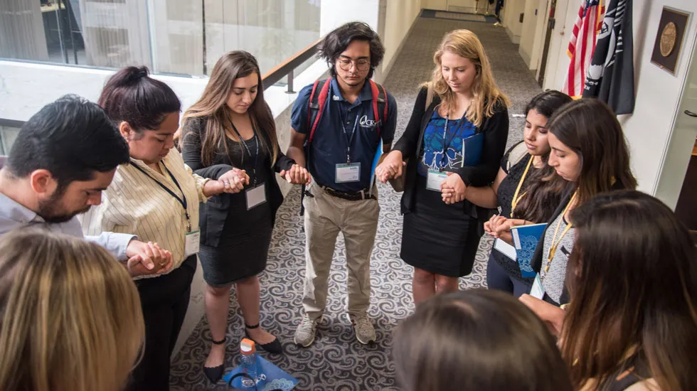 Student ambassadors from California universities gather for a prayer before going into Sen. Dianne Feinstein’s office in Washington, D.C., in July as part of the Catholic Relief Services' SALT Summit.