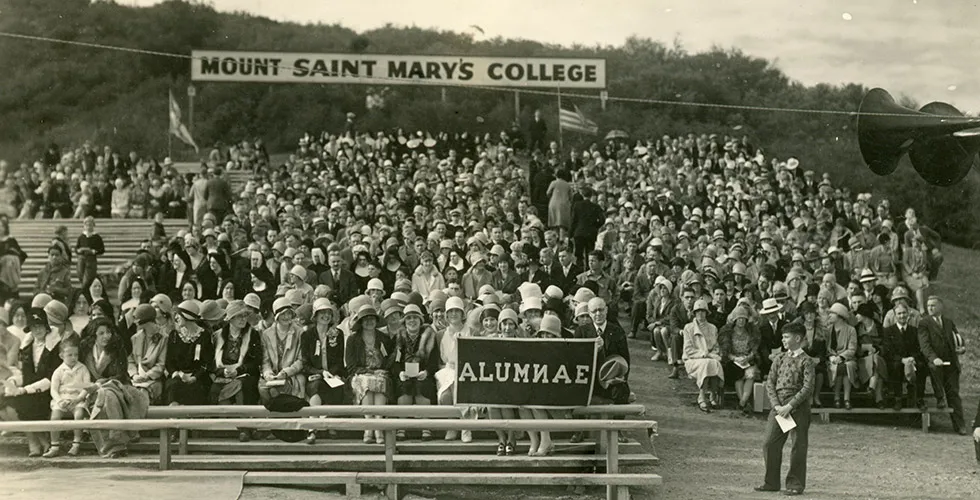 Students and family members unfurl an 