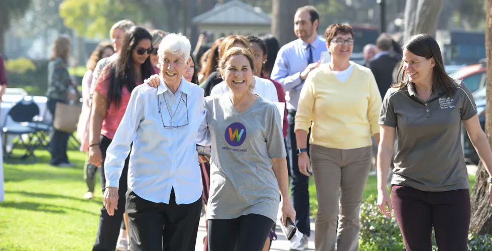 Sr. Kieran Vaughn, CSJ, President Ann McElaney-Johnson, and Autumn Johnson, director of sports and wellness, lead the inaugural Wellness Walk at the Doheny Campus on Jan. 29.