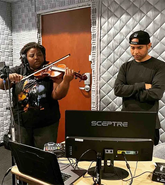 Lalibela Faraba ’25 and professor Derrick Skye at the University's recording studio working on their project this summer.
