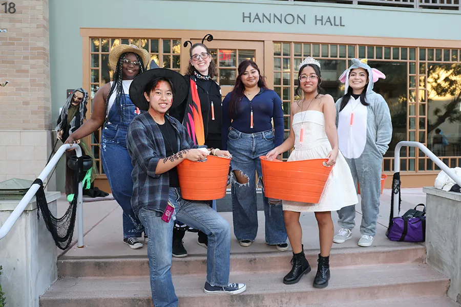 Mount students and Dean of Students Hilary Crocker, EdD (dressed up as a butterfly), in front of Hannon Hall waiting to deliver candy to thousands of guests.