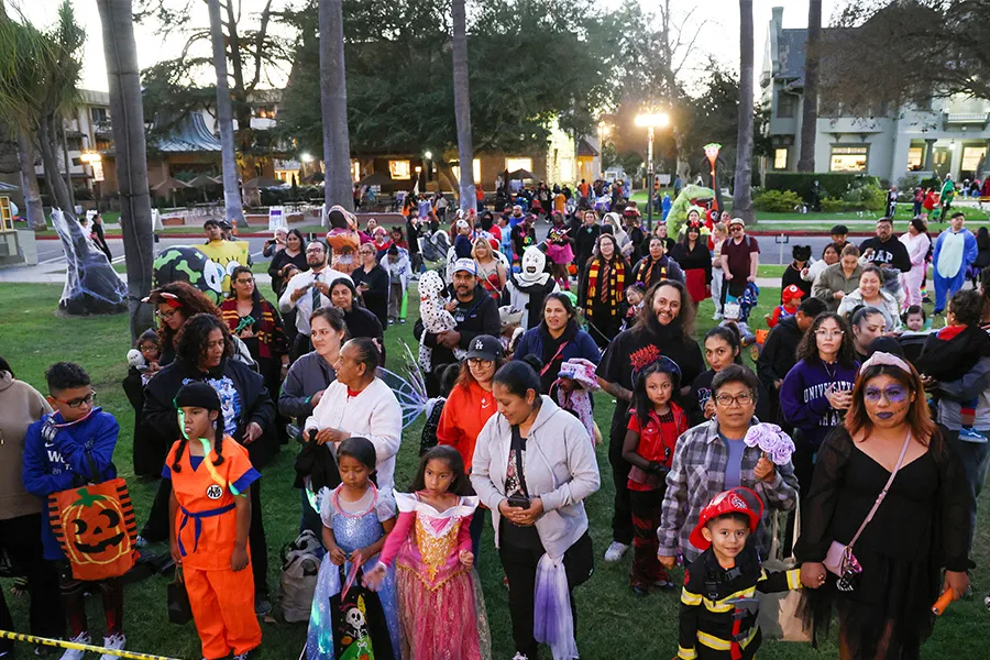 Families and children in costume eagerly gather in front of the Doheny Mansion ready to celebrate a spooky and fun-filled Halloween evening.