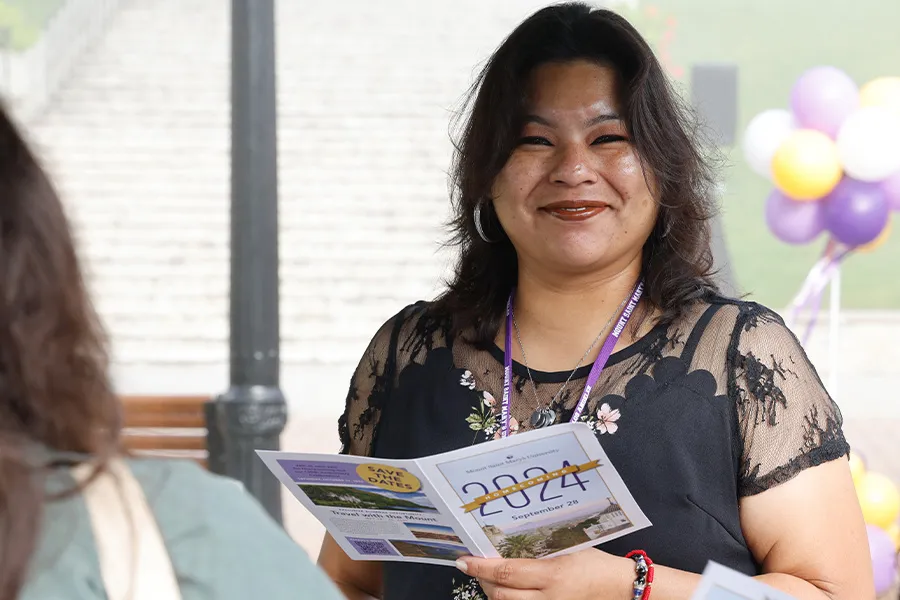 A Mount alumna smiles while enjoying the festivities of Homecoming 2024.