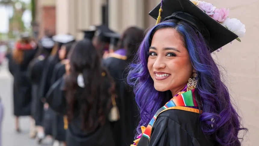 A graduate prepares to enter the Shrine Auditorium.