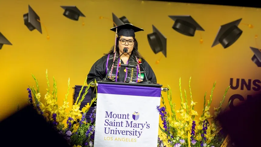 Aisha Barragan ’25, a psychology major and first-generation college student, speaks at the 2025 Undergraduate Commencement Ceremony.