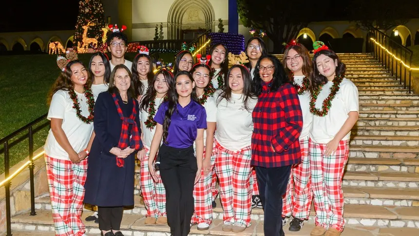 President Ann McElaney-Johnson, PhD (front row, second from left), Vice President for Student Affairs Linda McMurdock, PhD (front row, third from right), and SAC President Jettina Krantz ’27 (center, in purple) join members of Pangkat Pilipino in celebrating Lighting of the Circle.