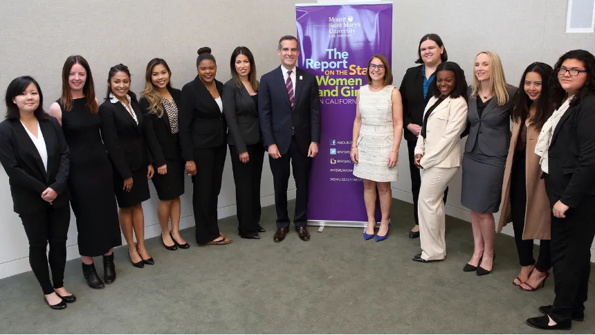 Sydnei Jones (fourth from right, in white suit) with former Los Angeles Mayor Eric Garcetti, ������ý President Ann McElaney-Johnson, PhD (sixth from right), former ������ý professor Jackie Filla, PhD (third from right), and other Mount students.