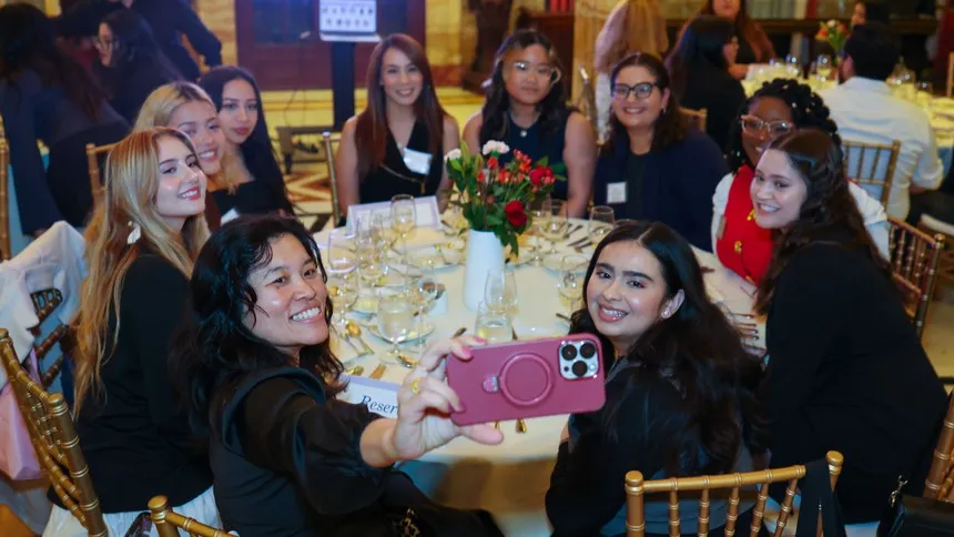 Around the table at the Doheny Mansion, students connect with alumnae mentors during the Purposeful Presence Etiquette and Networking Dinner.