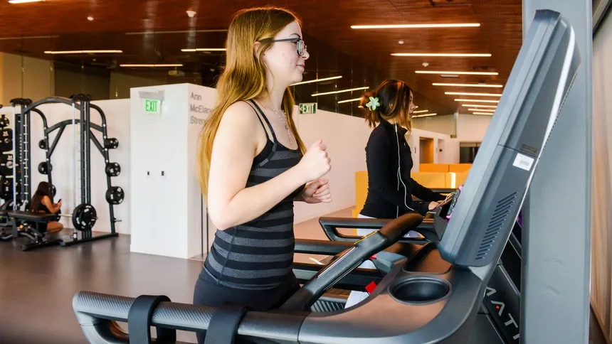 Students exercise on the treadmills inside the Michael A. Enright Wellness Pavilion, where daily movement supports focus, balance and overall well-being as part of campus life.