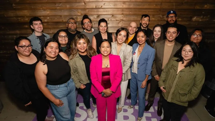 Lauren Hodgins ’10 (front row in blue suit) stands with Councilmember Ysabel Jurado (center, in pink suit) and her campaign team on election night on Nov. 5, 2024, celebrating a historic win for Los Angeles City Council District 14.