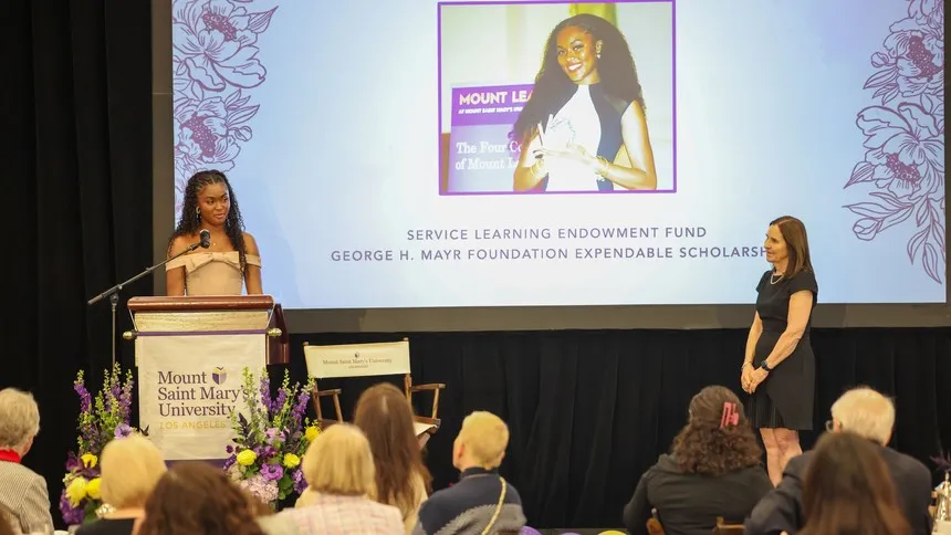 Lady Jones ’26 accepts the 2026 Unstoppable Scholar Award, as President McElaney-Johnson celebrates her achievements.