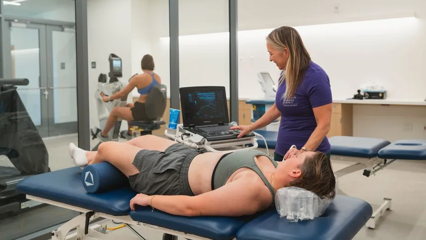 Physical therapy professor Dawn-Marie Ickes, PhD, guides a student through hands-on learning in the advanced training lab at the Michael A. Enright Wellness Pavilion, where clinical practice and academic instruction come together to support student success.