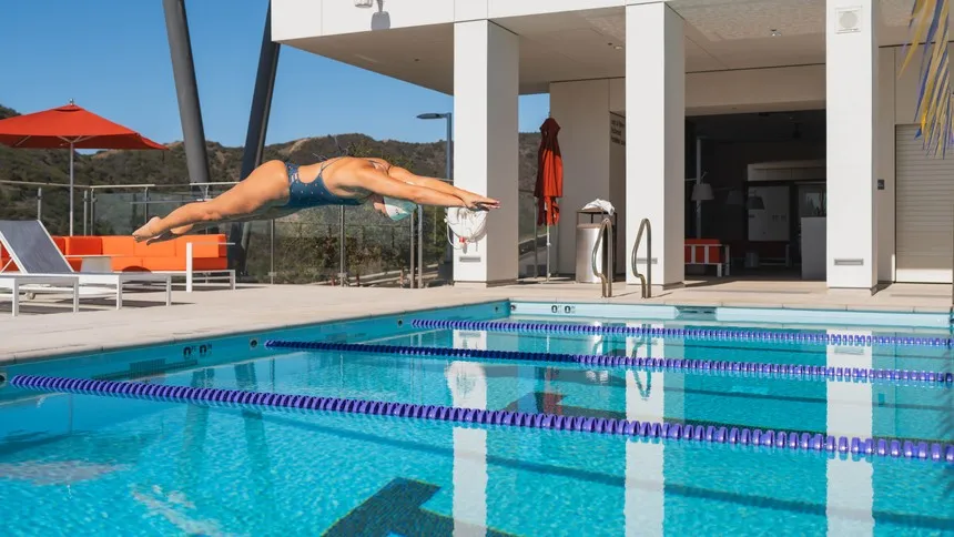 A student dives into the outdoor pool.