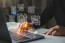 A graphic showing floating digital icons over a person's hand using a laptop