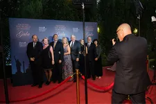 group of people posing for photo on red carpet