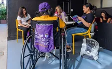 A group of students sitting around a table outside and studying