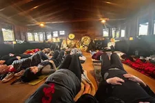 conference attendees laying down on the floor on their backs indoors while participating in a sound bath