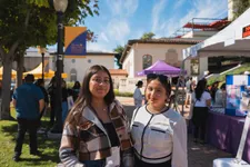 two female students smiling at an outdoor event