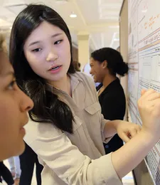 student talking about informational board