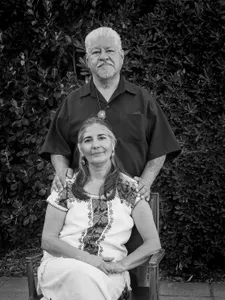 Luis and Trini Rodriguez smiling together in a black and white image