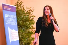 female speaker talking on stage